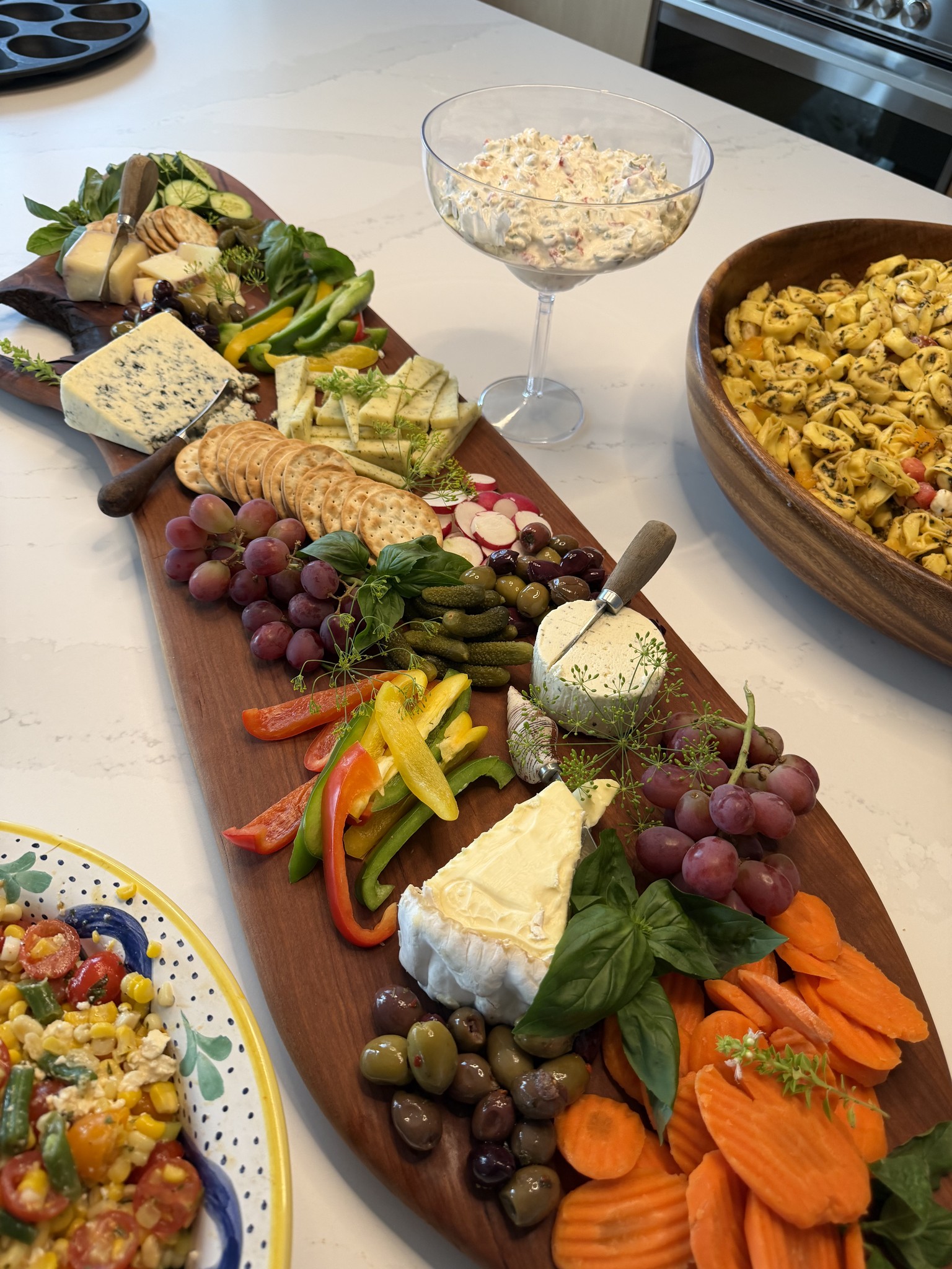 A colorful grazing board with cheeses and vegetables