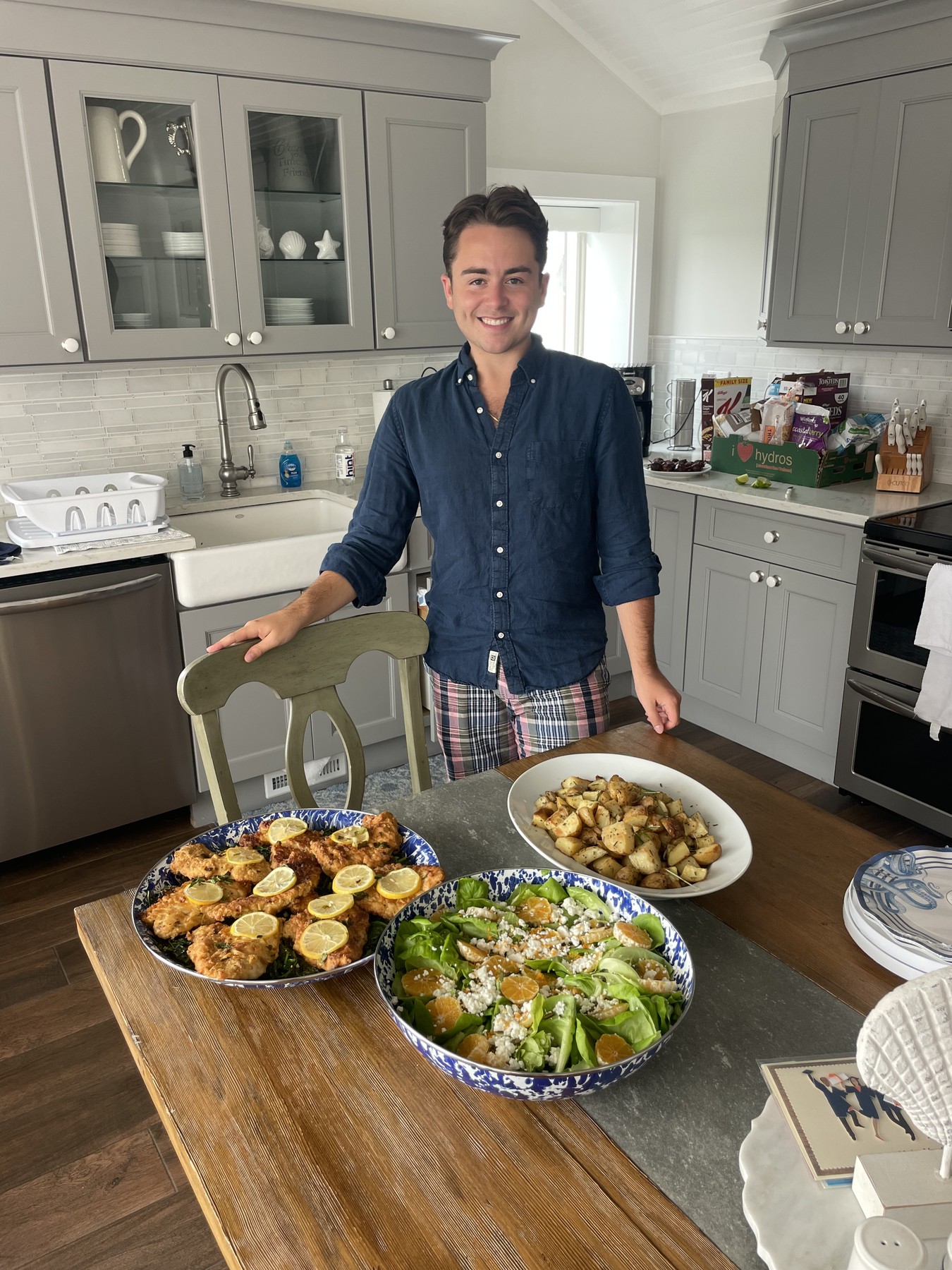 Sebastian with colorful catered dishes on a dining table