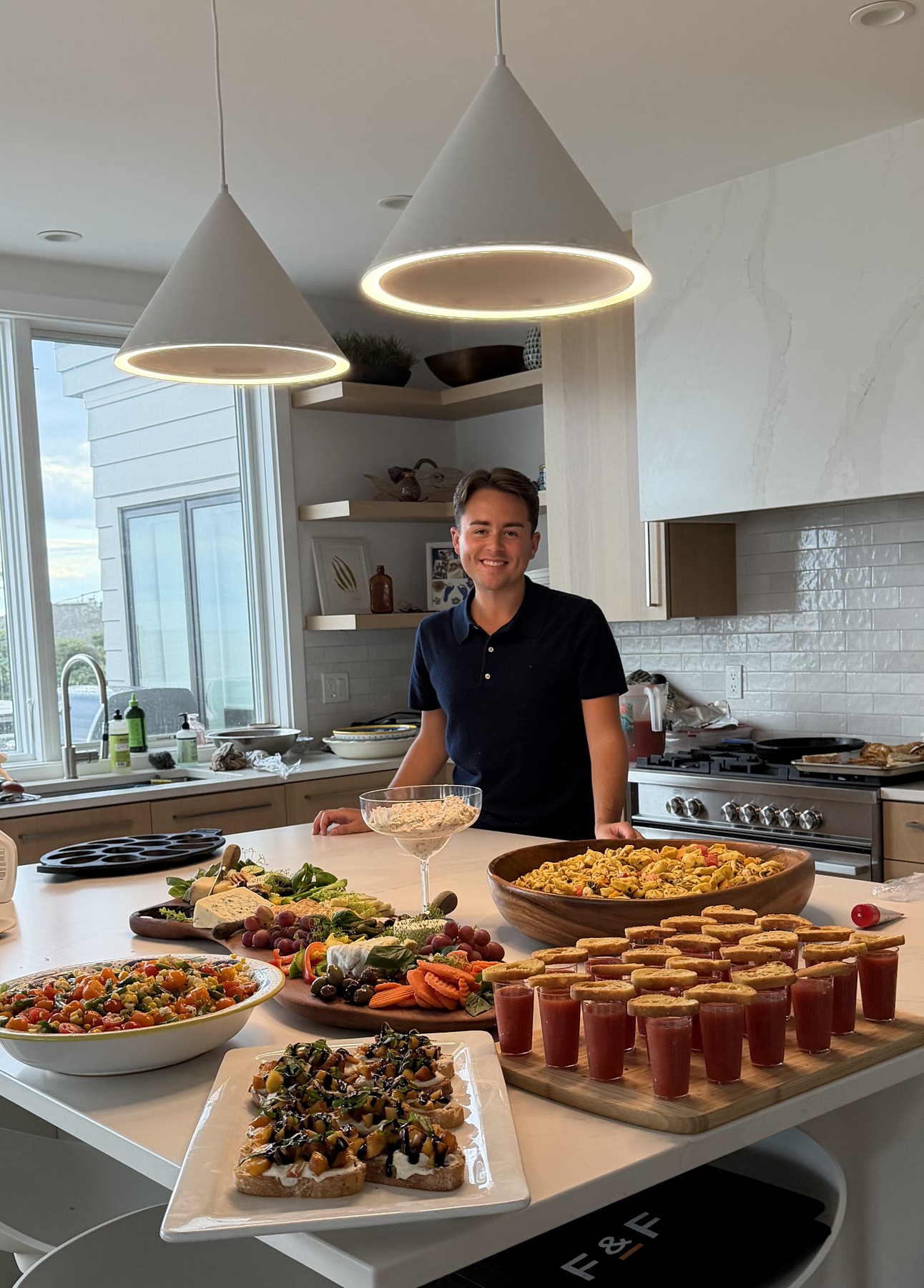 Sebastian presenting a catered spread in the kitchen